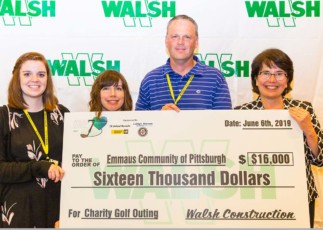 Image of Emmaus staff members and WALSH executive receiving benefit check.