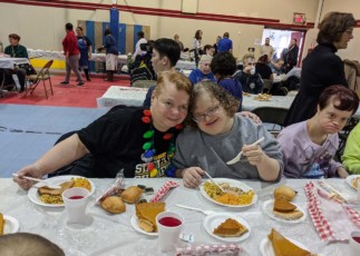 Image of Emmaus residents Amy and Gina at church Thanksgiving feast.