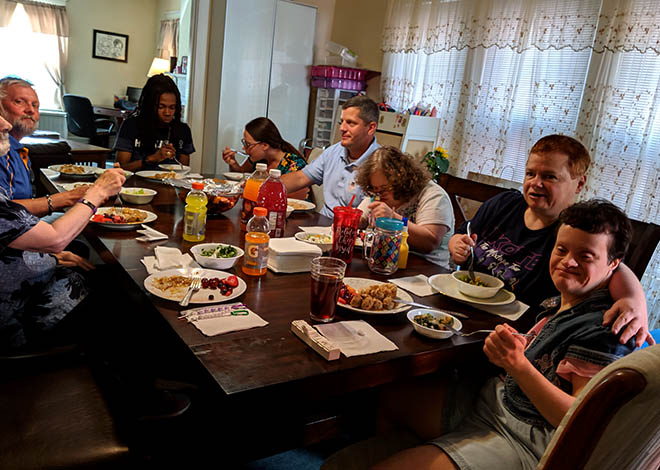 image of people with disabilities eating dinner in their permanent home