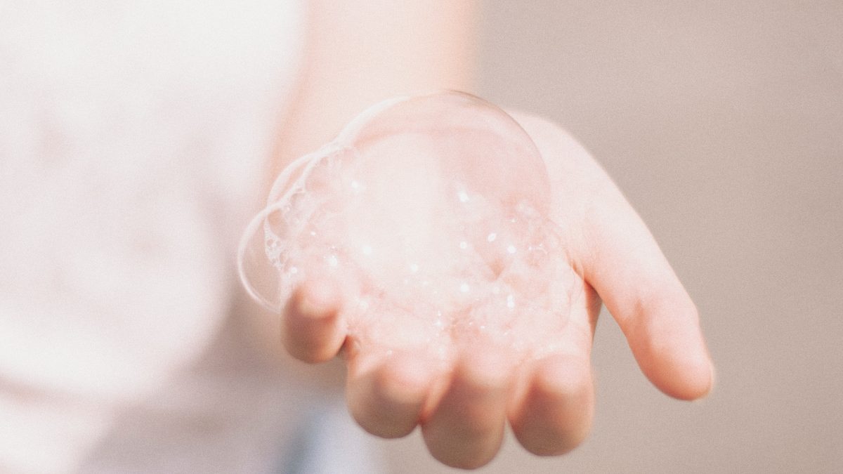 Image of hand holding soap bubbles.